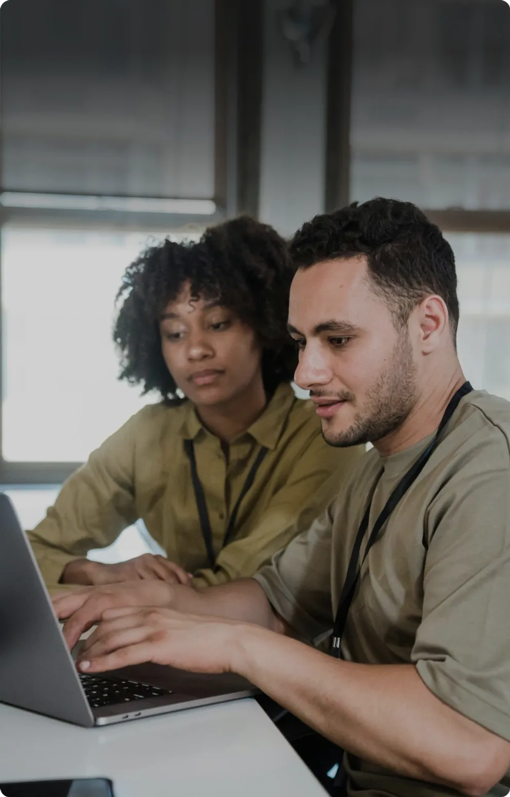 Two colleagues working together on a laptop