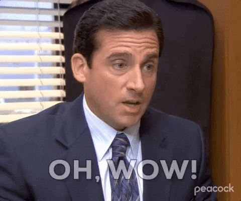 A man in a suit reacts, captioned oh wow