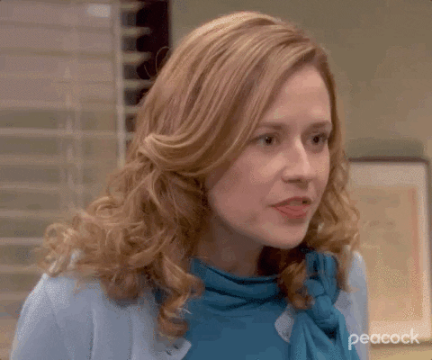 A woman glances sideways with a wry, sceptical look