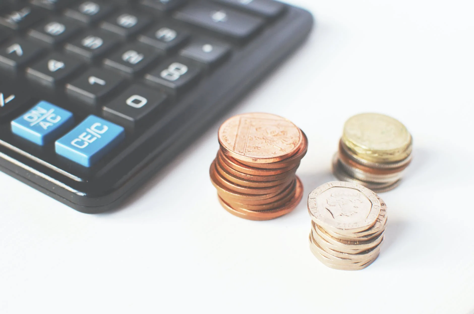A calculator a stack of coins