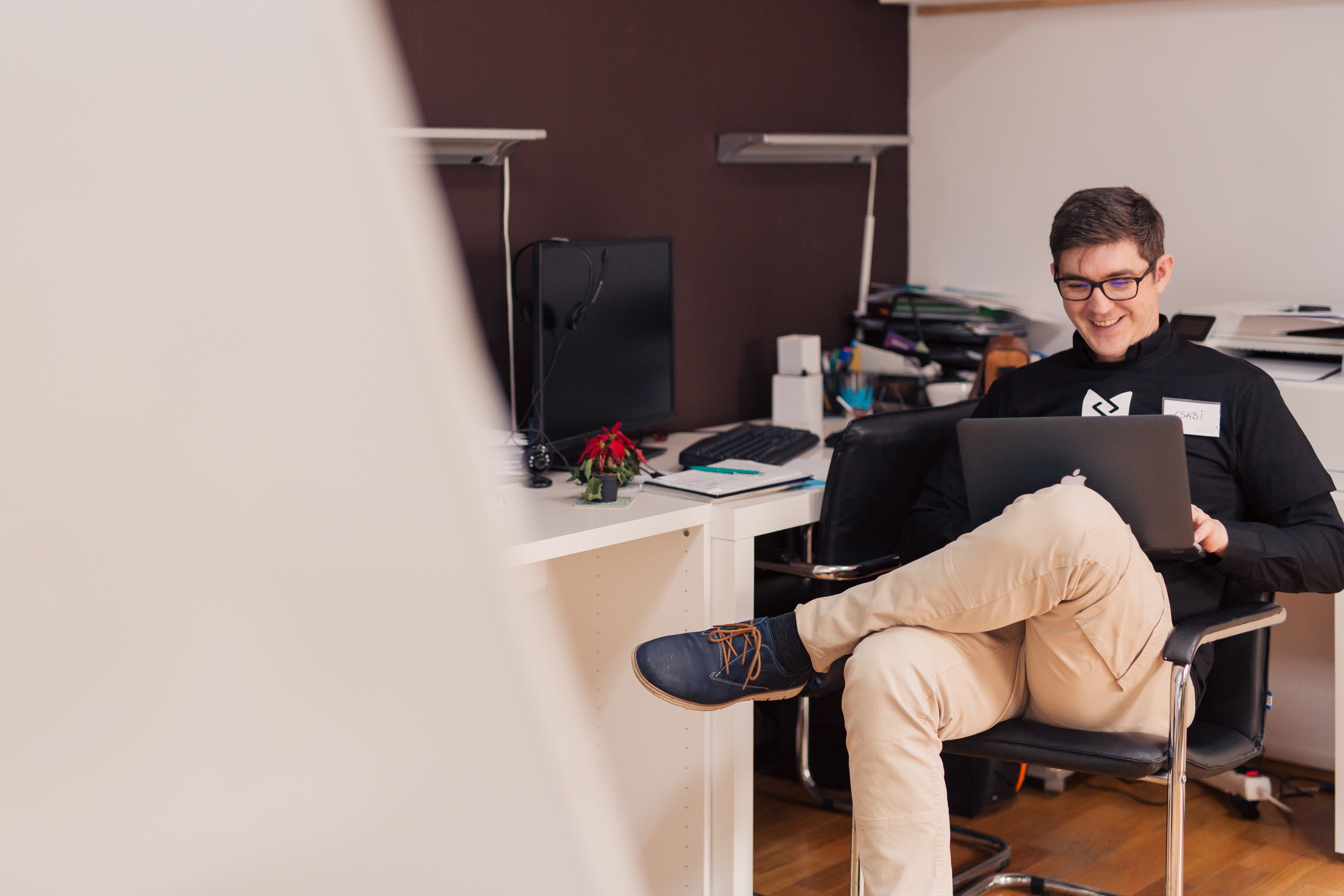 Happy employee working remotely with his laptop. CC: Unsplash
