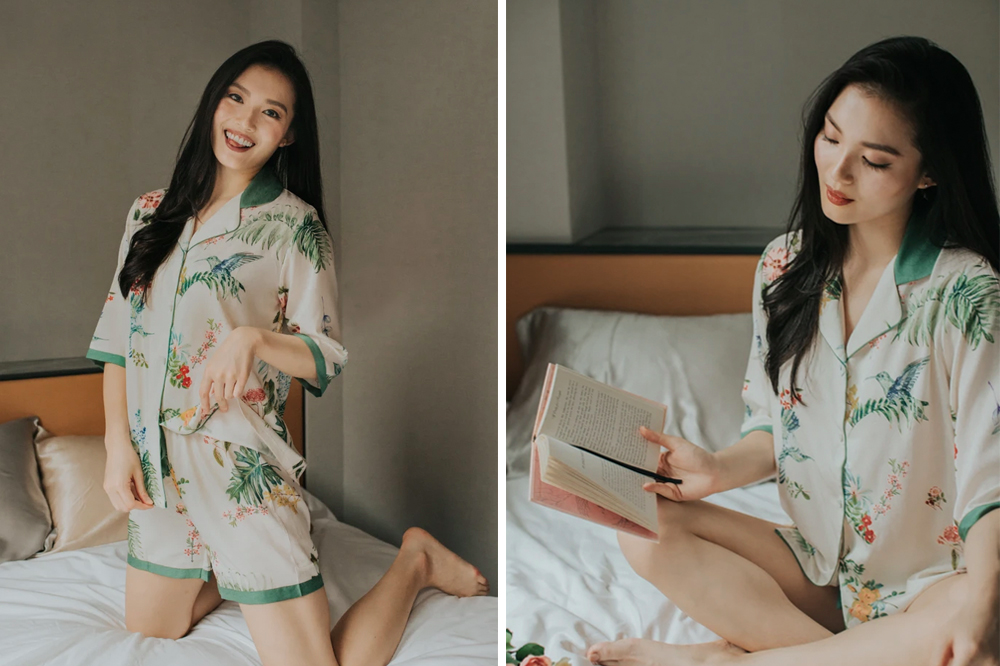 Two photos of a floral satin pyjama set worn at home, standing on a bed and sitting reading