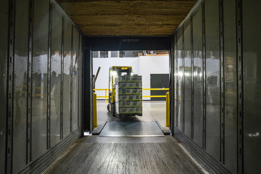 Forklift lifting stock in a warehouse